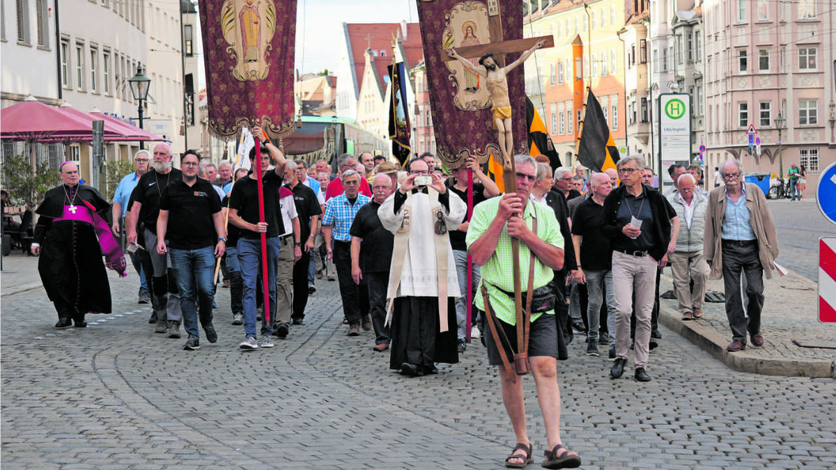 Fast am Ziel: Die Männer, die betend und singend durch Augsburgs Innenstadt zum Grab ihres Bistumspatrons pilgern, ziehen die Blicke auf sich. (Foto: Sitta)